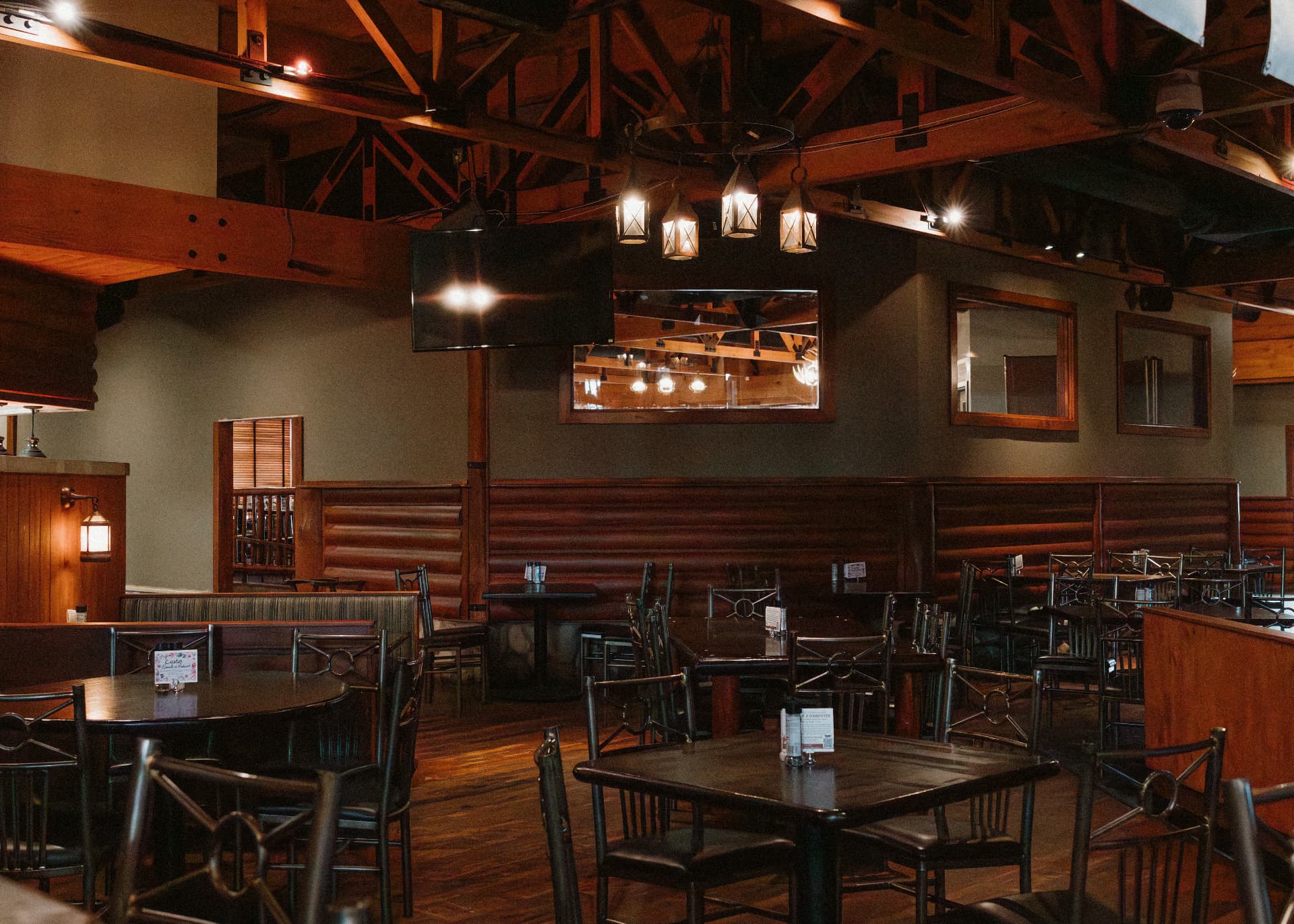 Redwood dining room with timber beams, lantern lighting and leather booths